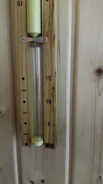 15-minute sand timer on the wooden wall inside our basement sauna