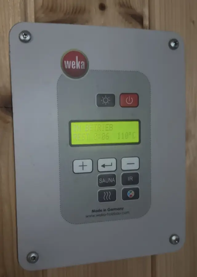 WEKA sauna wall control outside our basement sauna, display showing 110 °C